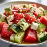 Watermelon cucumber feta salad served in a bowl, vibrant and refreshing dish