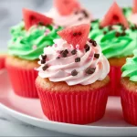 Delicious watermelon cupcakes topped with colorful frosting, perfect summer dessert.