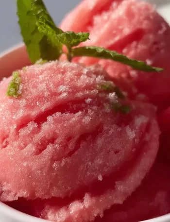 Delicious bowl of homemade watermelon sorbet served in a glass dish.