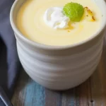 Bowl of chilled pineapple soup with garnishes as a refreshing summer dish