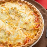 Crispy four-cheese tomato pie topped with crunchy crumbs
