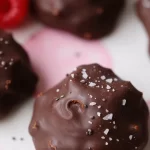 No-bake raspberry chocolate bites arranged on a plate, ready to eat.