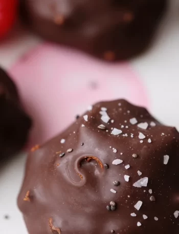 No-bake raspberry chocolate bites arranged on a plate, ready to eat.