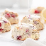 Freshly baked lemon raspberry scones on a plate for brunch.