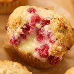 Delicious white chocolate raspberry muffins in a baking tray