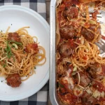 One-Pot Campfire Spaghetti Bake cooking over a campfire outdoors