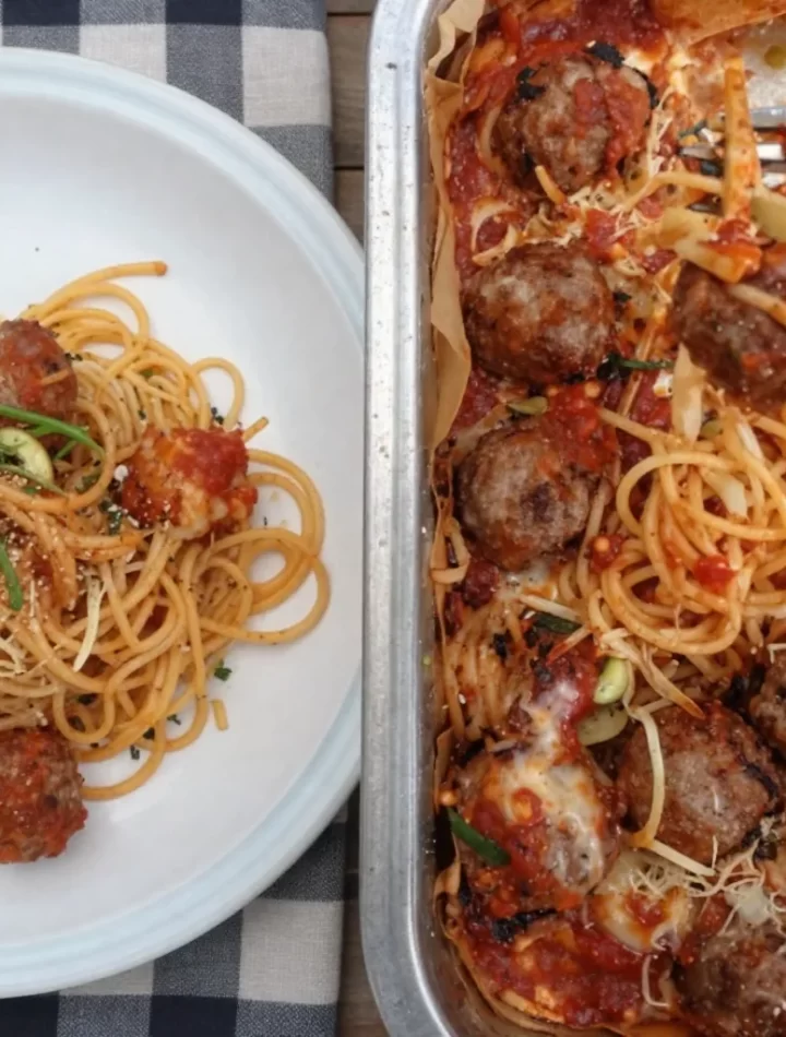 One-Pot Campfire Spaghetti Bake cooking over a campfire outdoors