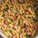 One-Pot Ham and Pea Pasta dish garnished with herbs