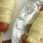 Kids roasting campfire hot dogs on a weekend camping trip