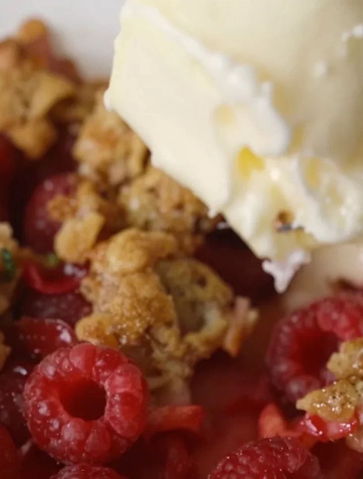 Delicious homemade Raspberry Crisp served in a dish, featuring tart berries and crunchy topping.