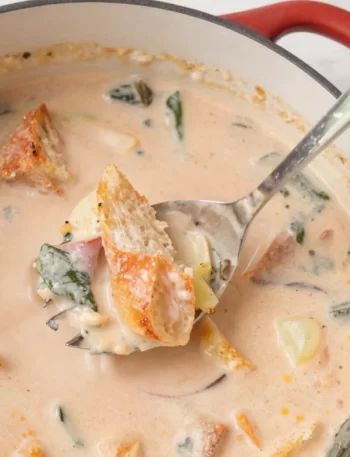 Seasonal summer vegetable stew served with buttered bread in a one-pot dish