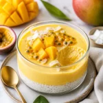 High-Protein Mango Passion Crémeux dessert in a bowl, topped with fresh mango.