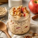 Bowl of Apple Cinnamon Overnight Oats topped with fresh apple slices and cinnamon