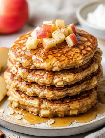 Plate of Minute Apple Cinnamon Protein Pancakes with syrup and apple slices